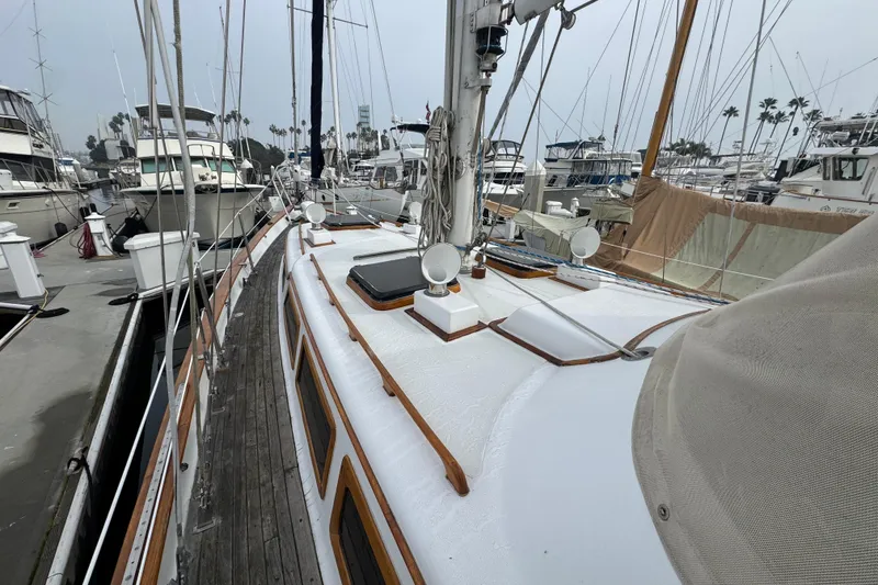 Slide: The Image of Sailboat deck with Yamaha outboard motor, Robert Perry 47, 1978 model, docked at marina. - 13