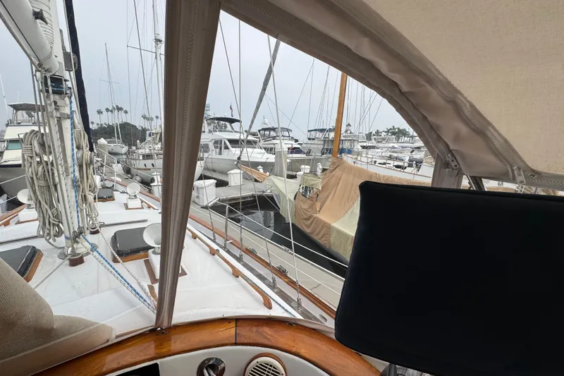 Slide: The Image of 1978 Robert Perry 47 sailboat docked at marina, featuring enclosed cockpit and visible rigging. - 15