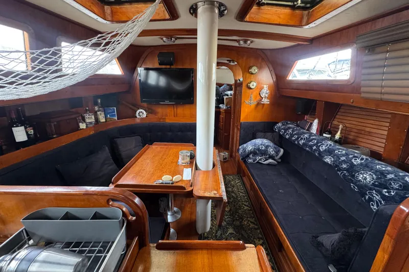 Slide: The Image of Interior of a 1978 Robert Perry 47 yacht with wood paneling and a fire extinguisher. - 21
