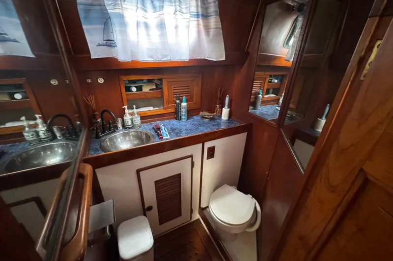 Slide: The Image of Cozy interior of a 1978 Robert Perry 47 yacht with wooden furnishings and seating. - 22
