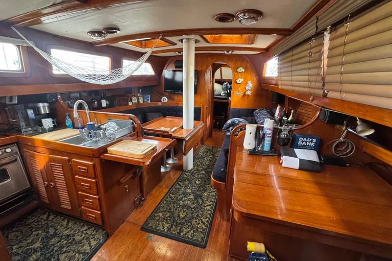 Slide: The Image of Cozy 1978 Robert Perry 47 yacht kitchen with wooden cabinetry and modern appliances. - 26