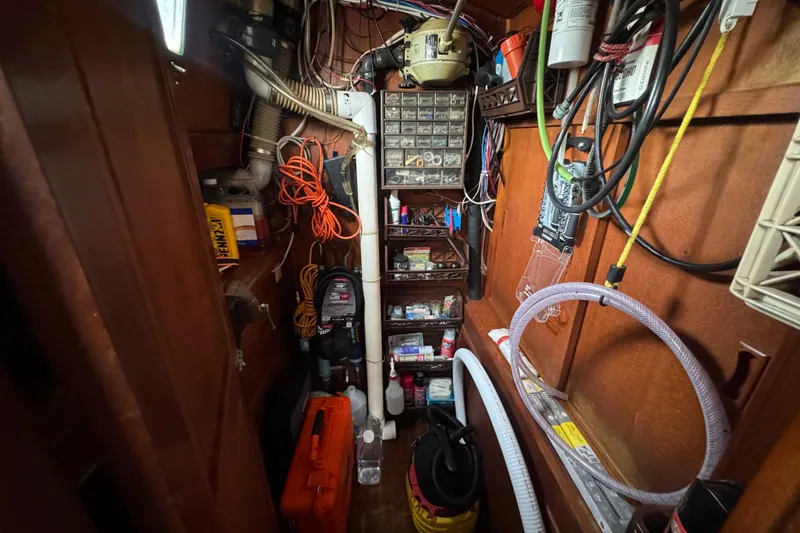 Slide: The Image of Interior of a 1978 Robert Perry 47 yacht with wooden furnishings and kitchen area. - 29