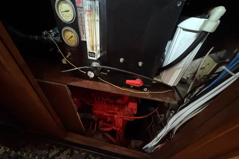 Slide: The Image of Interior view of a 1978 Robert Perry 47 sailboat, showing wooden paneling and wiring. - 32