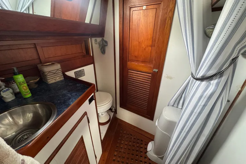 Slide: The Image of Wooden floor with exposed mechanical components on a 1978 Robert Perry 47 yacht. - 35