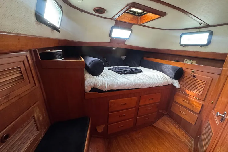 Slide: The Image of Bathroom interior of 1978 Robert Perry 47 yacht with wooden cabinetry and striped curtain. - 36