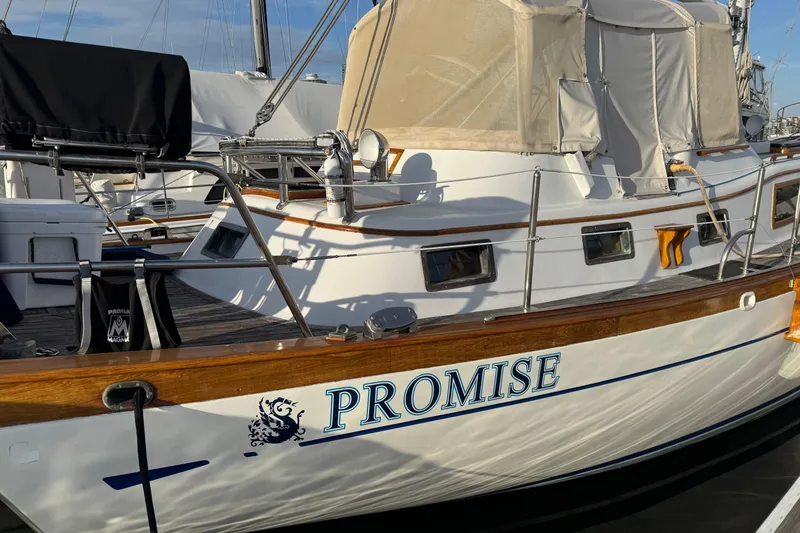 Slide: The Image of Classic 1978 Robert Perry 47 sailboat named "Promise" docked at marina. - 40