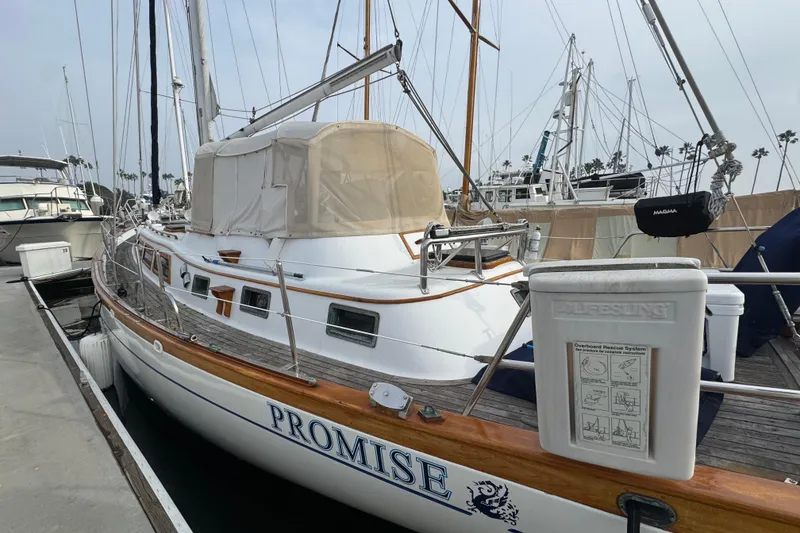 Slide: The Image of Sleek 1978 Robert Perry 47 yacht with polished anchor in marina setting. - 5