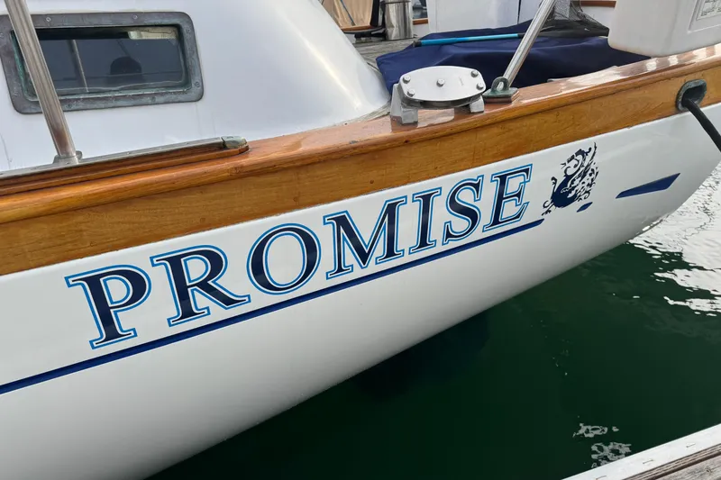 Slide: The Image of Sailboat "Promise" docked, Robert Perry 47 model, 1978, with covered cockpit and wooden accents. - 6