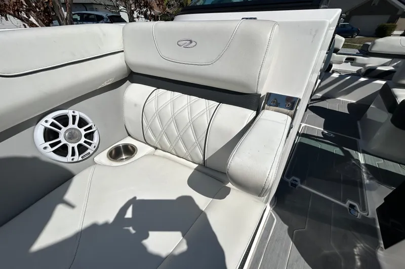 Slide: The Image of Luxurious interior of 2022 Regal LS2 boat with white seating and speaker. - 100
