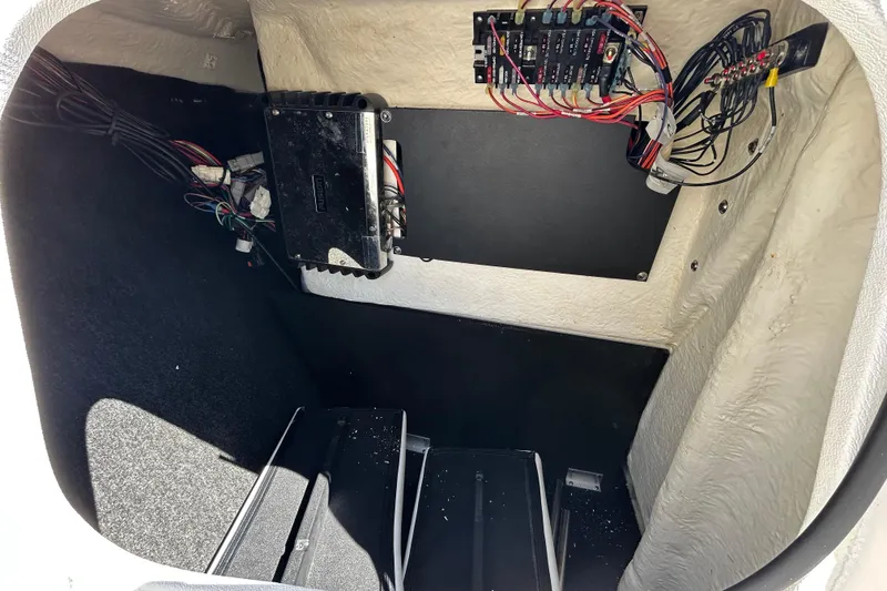 Slide: The Image of Electrical compartment of a 2022 Regal LS2 boat with wiring and components. - 103