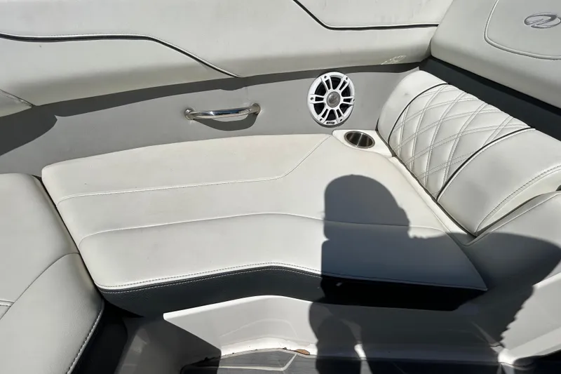 Slide: The Image of 2022 Regal LS2 boat interior with white leather seating and speaker. - 104