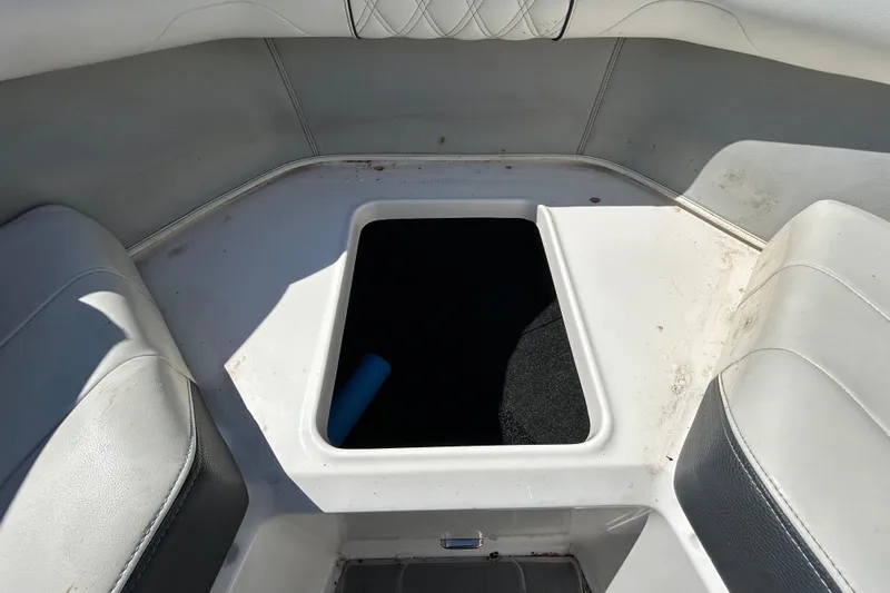 Slide: The Image of Interior storage compartment of a 2022 Regal LS2 boat, featuring white seating. - 108