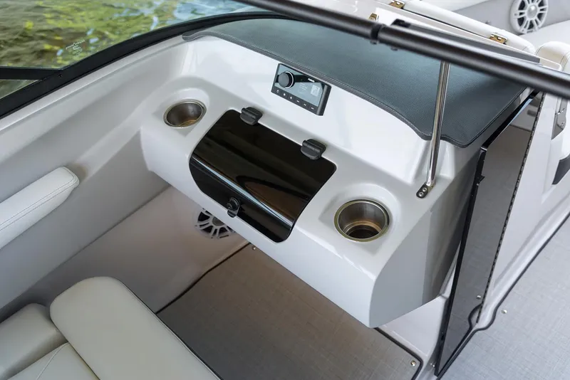 Slide: The Image of Manufacturer Provided Image: 2022 Regal LS2 boat interior with dashboard, cup holders, and storage compartment. - 11