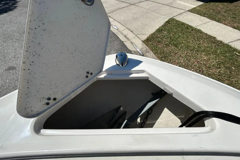 Slide: The Image of Open anchor compartment on 2022 Regal LS2 boat, showing anchor and chain storage. - 112