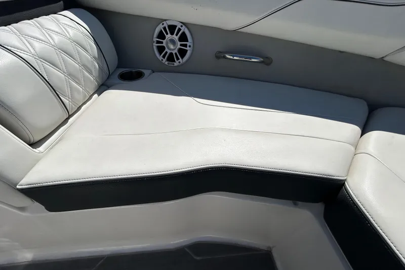 Slide: The Image of Luxurious white seating in 2022 Regal LS2 boat with speaker and cup holder. - 114
