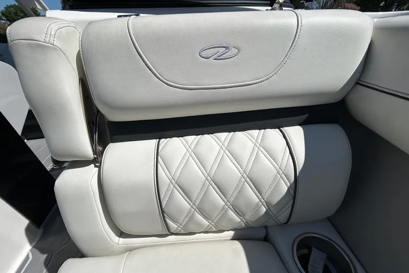 Slide: The Image of Luxurious white leather seating in a 2022 Regal LS2 boat interior. - 119