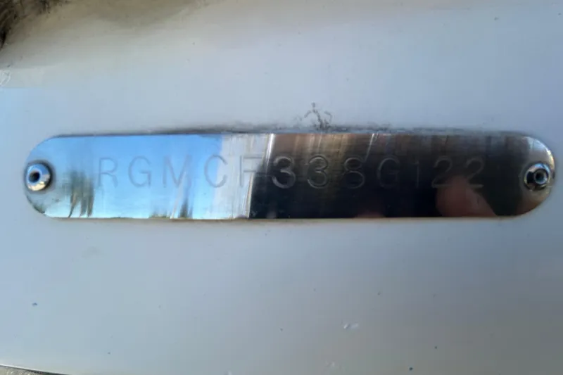 Slide: The Image of Metallic identification plate on a 2022 Regal LS2 boat. - 124