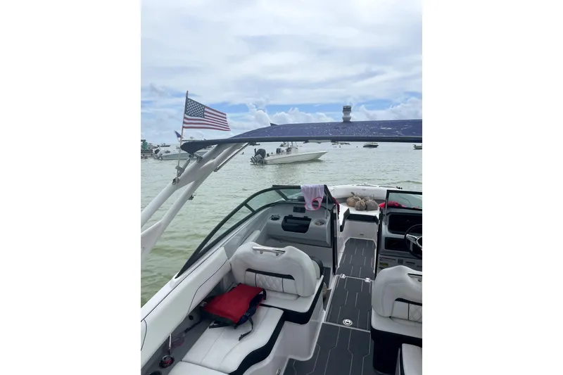 Slide: The Image of 2022 Regal LS2 boat interior with American flag, docked on a sunny day. - 17
