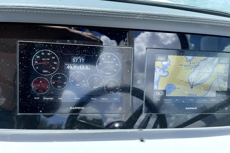 Slide: The Image of Dashboard of a 2022 Regal LS2 boat with Garmin navigation displays. - 18