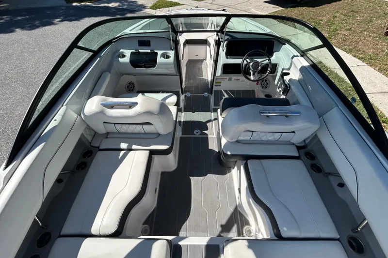 Slide: The Image of 2022 Regal LS2 boat interior with sleek seating and modern dashboard design. - 23