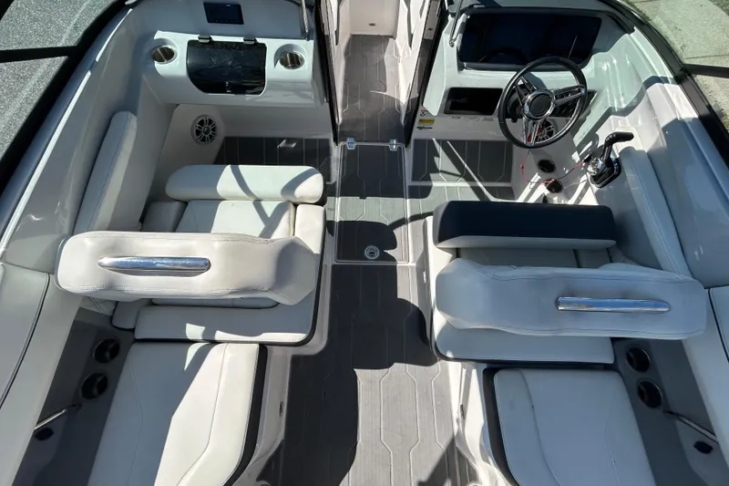 Slide: The Image of 2022 Regal LS2 boat interior with sleek seating and modern dashboard design. - 25