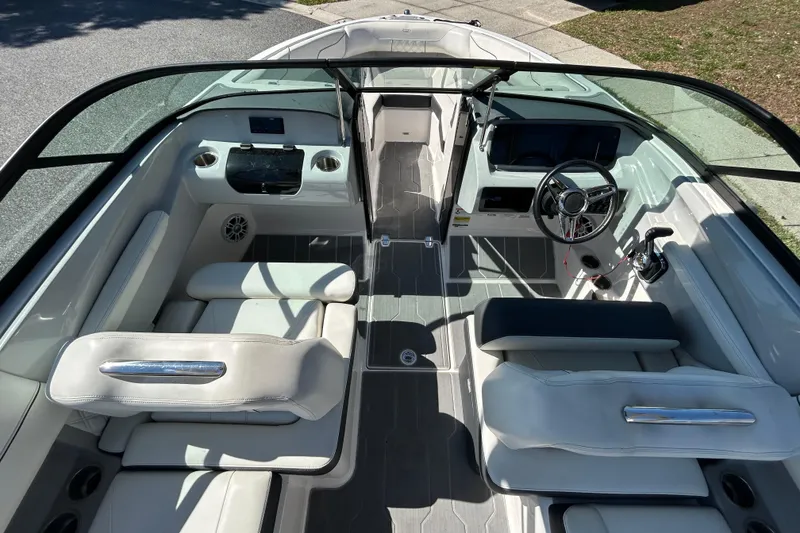 Slide: The Image of 2022 Regal LS2 boat interior with modern seating and steering wheel. - 26