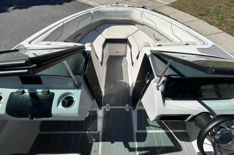 Slide: The Image of 2022 Regal LS2 boat interior with sleek seating and modern dashboard design. - 28