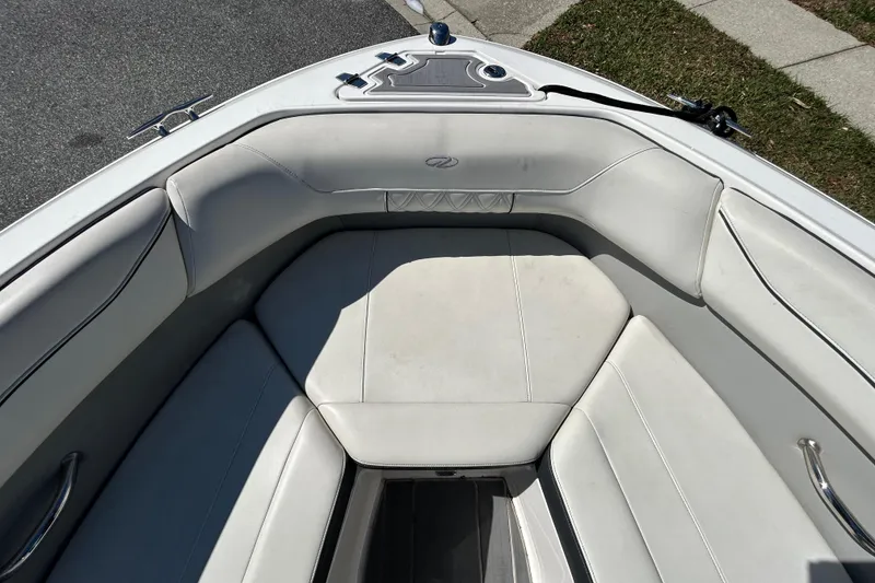 Slide: The Image of 2022 Regal LS2 boat interior with white cushioned seating and stainless steel accents. - 30