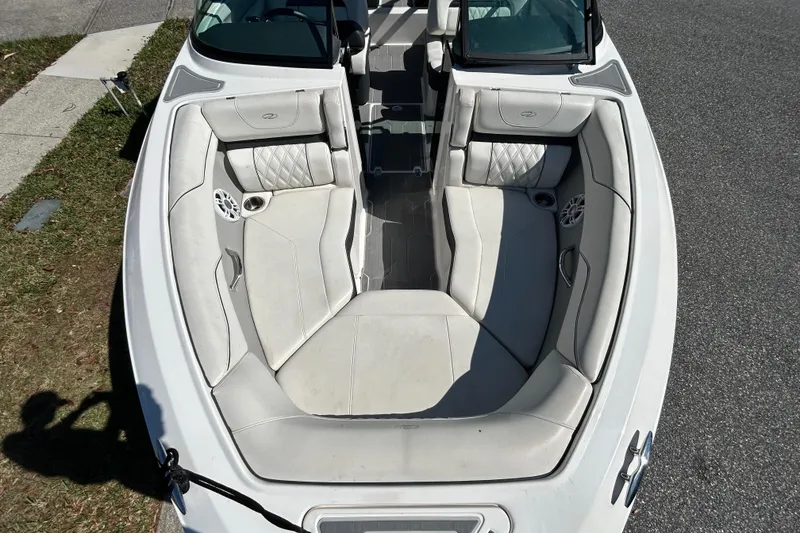 Slide: The Image of 2022 Regal LS2 boat interior with white cushioned seating and speaker system. - 31