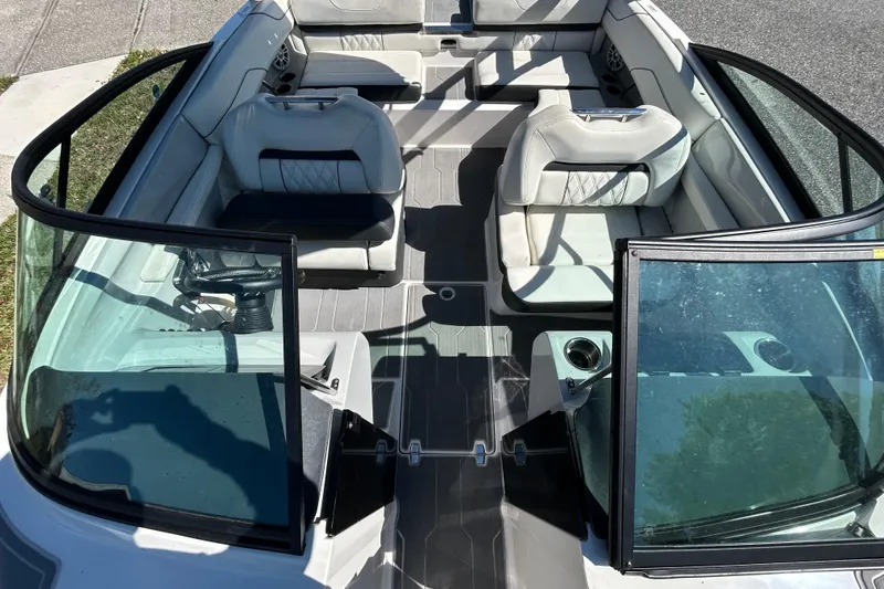 Slide: The Image of 2022 Regal LS2 boat interior with white seating and open windshield. - 35