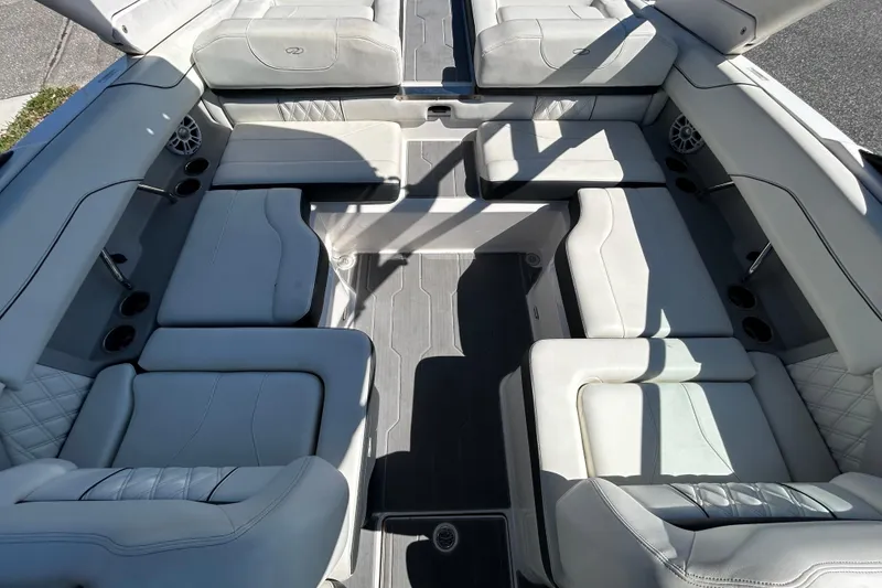 Slide: The Image of 2022 Regal LS2 boat interior with luxurious white seating and cup holders. - 39