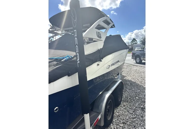 Slide: The Image of 2022 Regal LS2 boat on trailer under clear sky. - 4