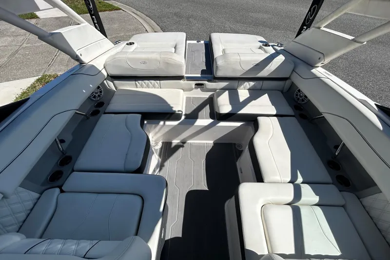Slide: The Image of Luxurious 2022 Regal LS2 boat interior with spacious white seating and cup holders. - 40