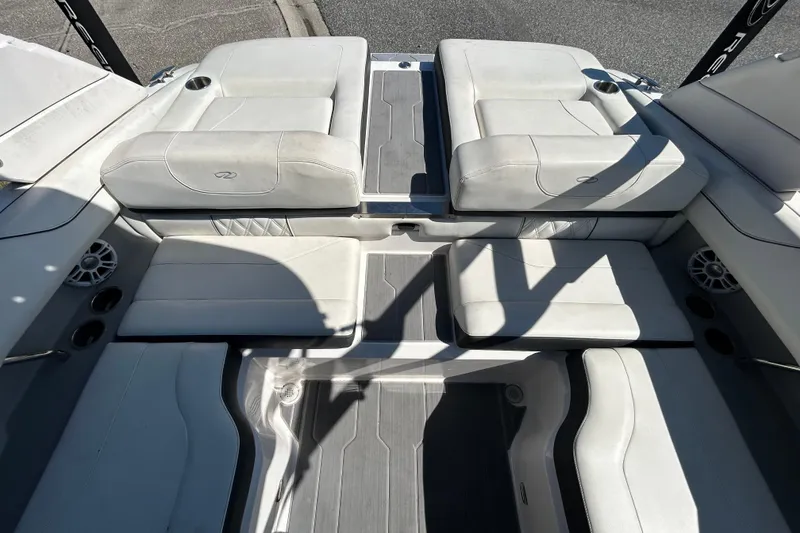 Slide: The Image of 2022 Regal LS2 boat interior with white seating and cup holders. - 41