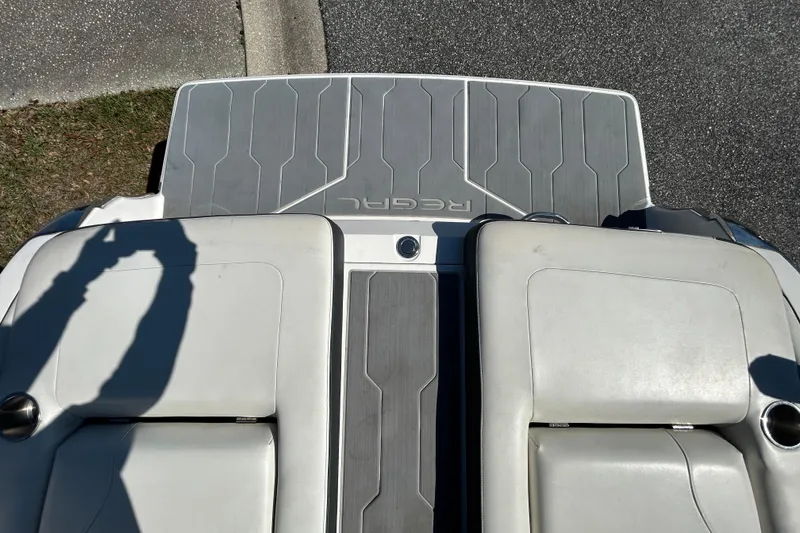 Slide: The Image of 2022 Regal LS2 boat with gray deck and white seating, viewed from above. - 43