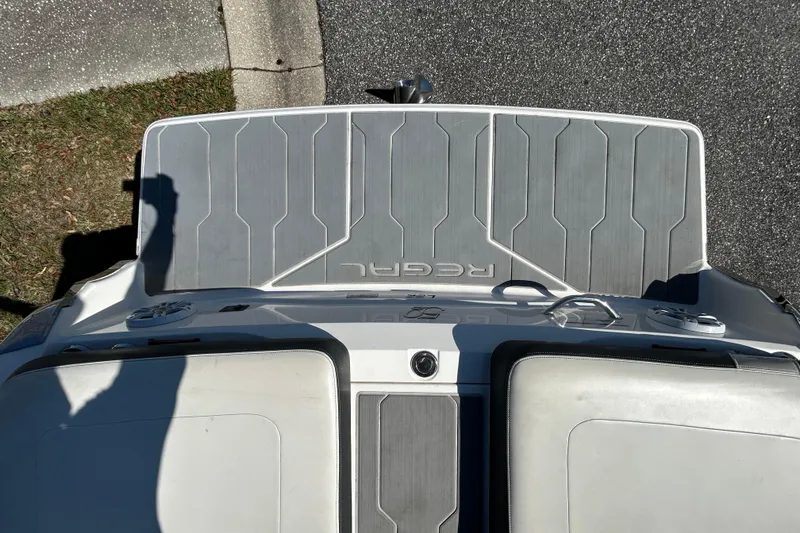 Slide: The Image of 2022 Regal LS2 boat deck with gray non-slip surface and branding. - 44