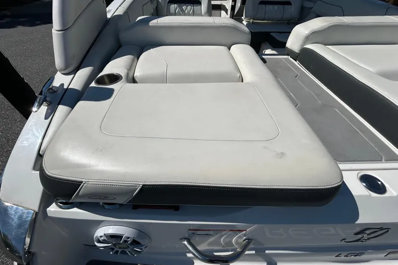 Slide: The Image of 2022 Regal LS2 boat with white leather seating and cup holder. - 48