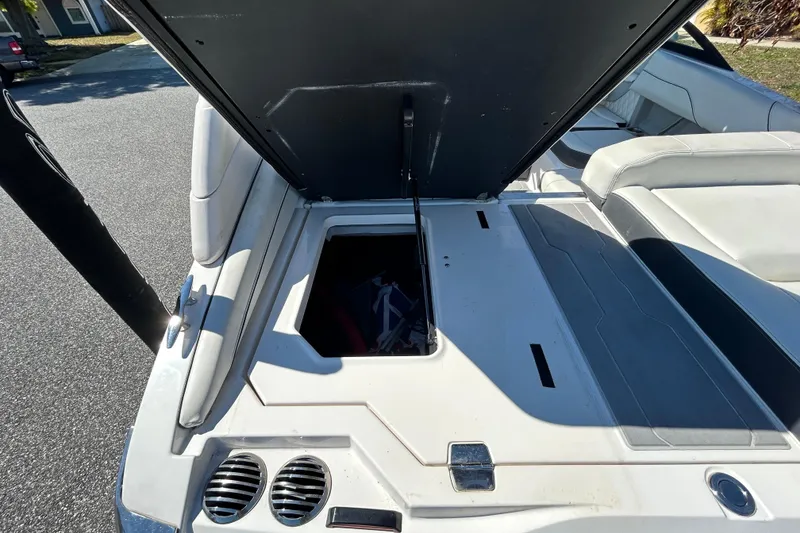 Slide: The Image of 2022 Regal LS2 boat with open storage compartment and seating area. - 49