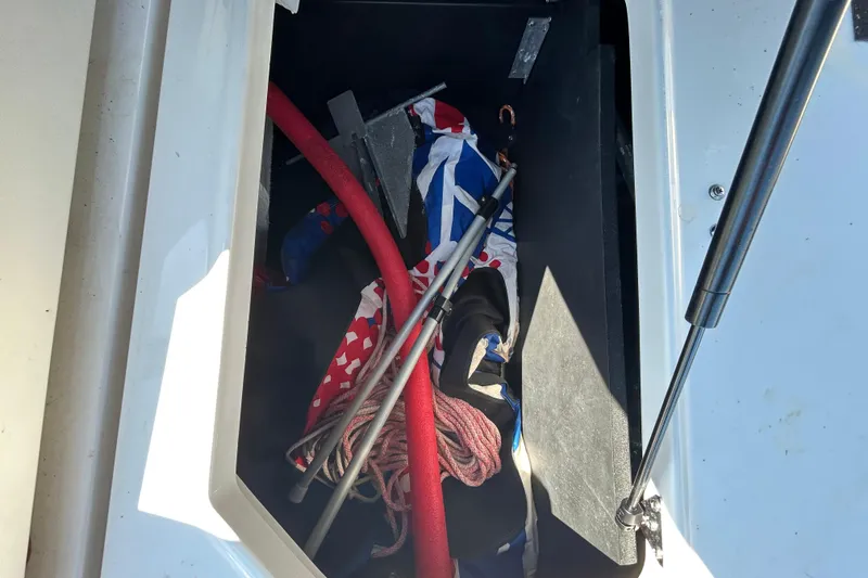 Slide: The Image of Storage compartment of 2022 Regal LS2 boat with ropes and equipment. - 50