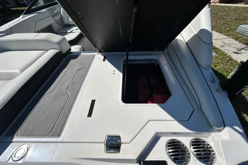 Slide: The Image of 2022 Regal LS2 boat interior with open storage compartment and seating area. - 52