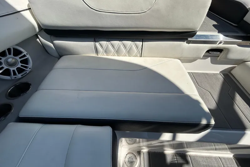 Slide: The Image of 2022 Regal LS2 boat interior with white leather seating and speaker system. - 56