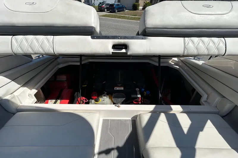 Slide: The Image of 2022 Regal LS2 boat engine compartment with open hatch, showcasing interior components. - 61