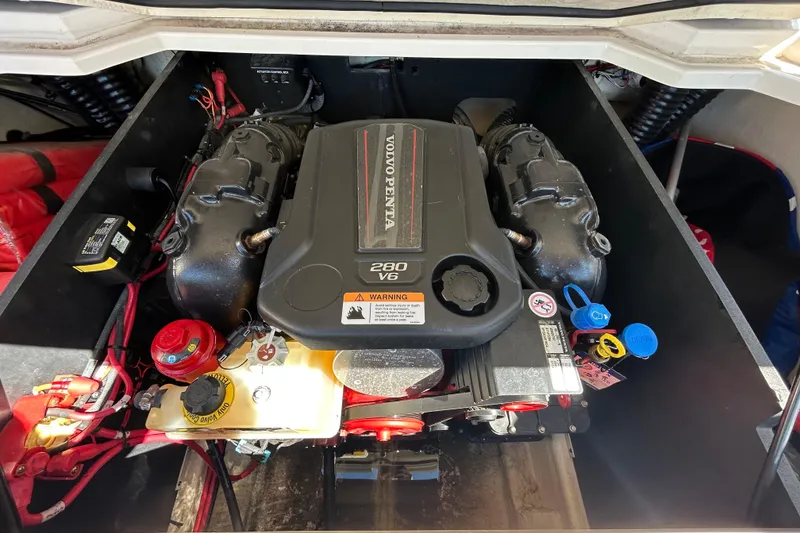 Slide: The Image of Engine compartment of a 2022 Regal LS2 boat featuring a Volvo Penta 280 V6 engine. - 65
