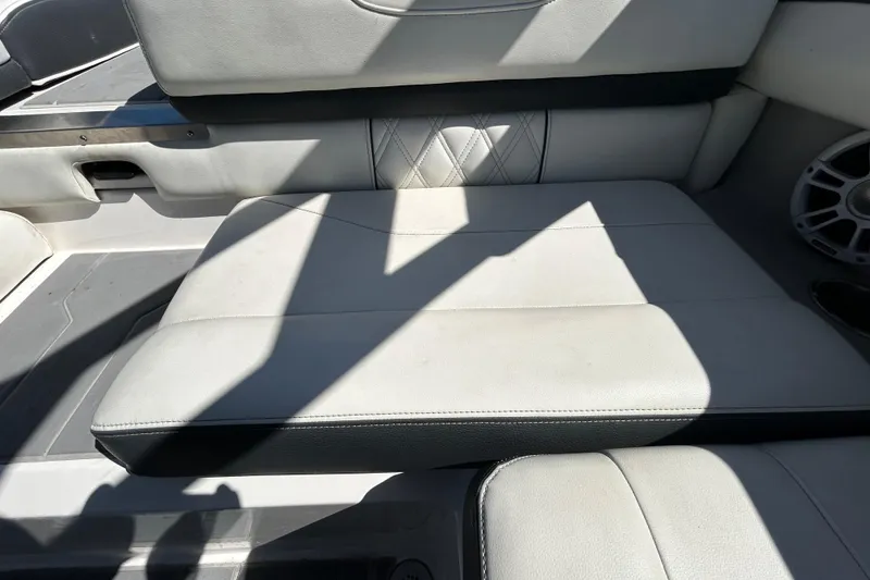 Slide: The Image of 2022 Regal LS2 boat interior with white leather seating and speaker. - 68