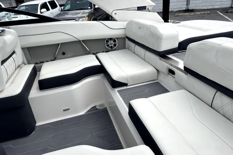 Slide: The Image of 2022 Regal LS2 boat interior with white and navy seating, featuring modern design and speaker system. - 7