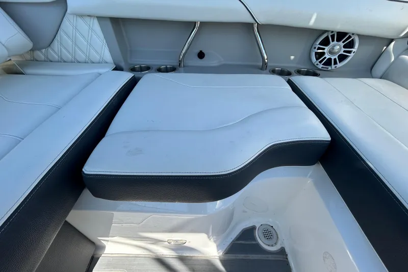 Slide: The Image of 2022 Regal LS2 boat interior with white seating and speaker. - 71