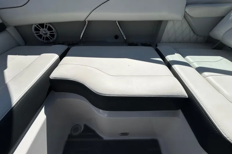 Slide: The Image of 2022 Regal LS2 boat interior with cushioned seating and speaker. - 74