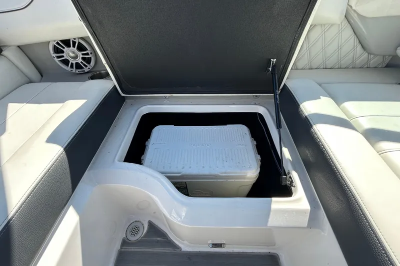 Slide: The Image of 2022 Regal LS2 boat storage compartment with cooler inside. - 75