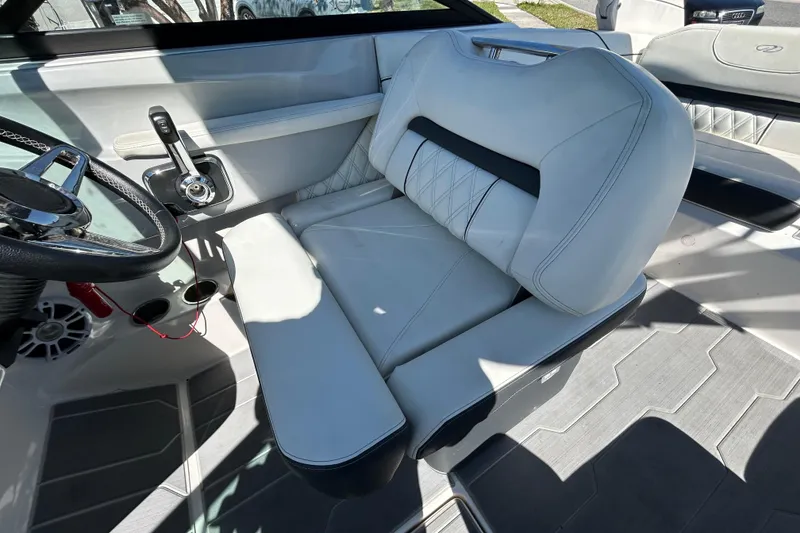 Slide: The Image of Interior of a 2022 Regal LS2 boat featuring a sleek, modern helm seat. - 78