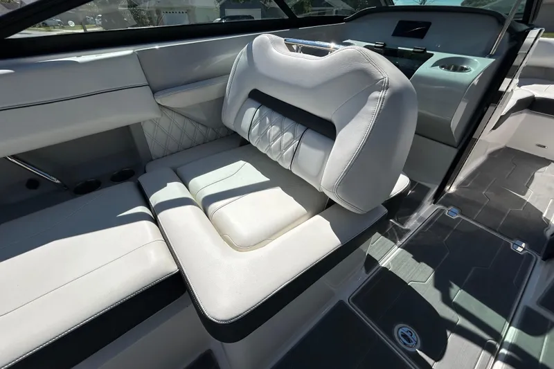 Slide: The Image of Luxurious interior seating of a 2022 Regal LS2 boat, featuring elegant white upholstery. - 79